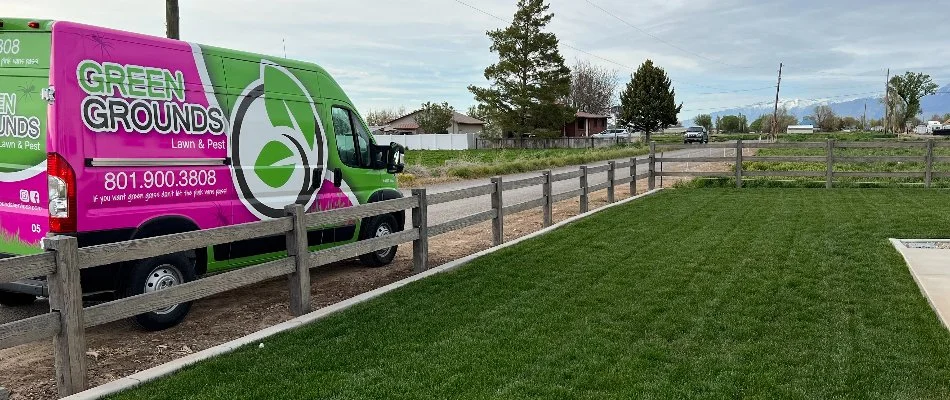 A company truck in front of a vibrant, green lawn on a property in Taylorsville, UT.