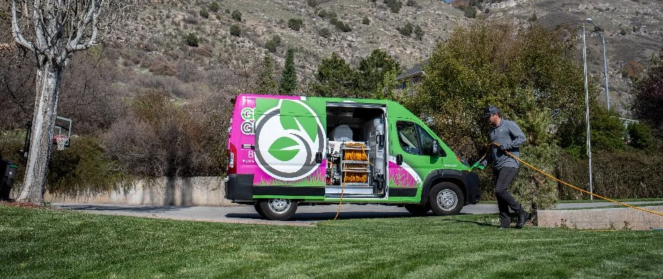 A lawn care professional performing a service on a lawn in Midway, UT.